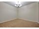 Empty dining room features neutral walls, carpet, and an ornate chandelier at 4500 Fieldview Cir, Wesley Chapel, FL 33545