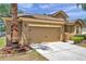 Beige two-car garage with decorative hardware, fresh landscaping, and mature palm tree at 4500 Fieldview Cir, Wesley Chapel, FL 33545