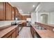 Well-lit kitchen featuring stainless steel appliances, wooden cabinets, and light wood-look flooring at 4500 Fieldview Cir, Wesley Chapel, FL 33545