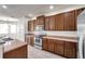 Bright kitchen with ample cabinet space, stainless steel appliances, and wood-look tile floors at 4500 Fieldview Cir, Wesley Chapel, FL 33545