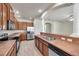 Modern kitchen featuring stainless steel appliances, wood cabinets, and breakfast bar with double sink at 4500 Fieldview Cir, Wesley Chapel, FL 33545