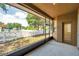 Enclosed lanai with a backyard view of a playground and white picket fence at 4500 Fieldview Cir, Wesley Chapel, FL 33545