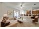 Open concept living room area with view of kitchen and sliding glass doors at 4500 Fieldview Cir, Wesley Chapel, FL 33545