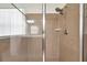 A shower room with tiled walls, glass door and shower head with attached hose at 4500 Fieldview Cir, Wesley Chapel, FL 33545