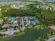 Aerial view showcases a community with tennis courts, a pool, a playground, parking and a scenic landscape at 4719 Tramanto Ln, Wesley Chapel, FL 33543
