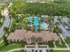 Amazing aerial view of the luxurious Estancia community featuring a resort-style pool and lush greenery at 4719 Tramanto Ln, Wesley Chapel, FL 33543