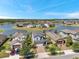 Beautiful aerial view of homes surrounding a scenic lake in a well-maintained community at 4719 Tramanto Ln, Wesley Chapel, FL 33543