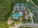 Aerial view of the Estancia community, boasting a resort-style pool, tennis courts, and a playground at 4719 Tramanto Ln, Wesley Chapel, FL 33543