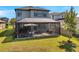 A screened patio with outdoor seating offers a cozy space to enjoy backyard views at 4719 Tramanto Ln, Wesley Chapel, FL 33543