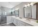Modern bathroom features dual sinks, quartz countertops, and a glass-enclosed shower at 4719 Tramanto Ln, Wesley Chapel, FL 33543