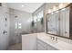 Contemporary bathroom boasts sleek tilework, glass shower enclosure and modern vanity with storage at 4719 Tramanto Ln, Wesley Chapel, FL 33543