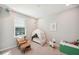 Cozy bedroom with a tent, plush chair, and a window providing natural light at 4719 Tramanto Ln, Wesley Chapel, FL 33543