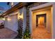 A covered entryway with brick paving, leading to a home's bright, welcoming interior at 4719 Tramanto Ln, Wesley Chapel, FL 33543