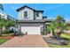 Charming two-story home with a well-maintained lawn and an attached two-car garage at 4719 Tramanto Ln, Wesley Chapel, FL 33543