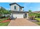 Beautiful two-story home with a two-car garage, lovely landscaping, and inviting curb appeal at 4719 Tramanto Ln, Wesley Chapel, FL 33543