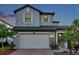 Charming two-story home featuring a brick driveway, two-car garage, and beautifully landscaped front yard at 4719 Tramanto Ln, Wesley Chapel, FL 33543