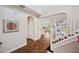 Inviting foyer featuring hardwood floors, staircase, and arched entryway, leading to open living space at 4719 Tramanto Ln, Wesley Chapel, FL 33543