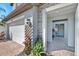 Inviting front entrance with brick pavers, beautiful landscaping, and a view of the home's interior at 4719 Tramanto Ln, Wesley Chapel, FL 33543
