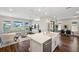 Bright, open-concept living space with modern island, farmhouse sink and stainless steel appliances with views of the backyard at 4719 Tramanto Ln, Wesley Chapel, FL 33543