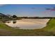 Scenic lake view surrounded by lush greenery and neighborhood homes in the distance at 4719 Tramanto Ln, Wesley Chapel, FL 33543
