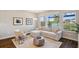 Bright living room features comfortable seating, large windows with water views and stylish decor, creating a relaxing atmosphere at 4719 Tramanto Ln, Wesley Chapel, FL 33543