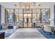 Lobby area with stylish furniture, rugs, and a view into a gathering area at 4719 Tramanto Ln, Wesley Chapel, FL 33543