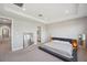Serene bedroom featuring neutral tones, modern decor, and access to the main bathroom at 4719 Tramanto Ln, Wesley Chapel, FL 33543