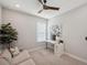 Bright home office featuring neutral colors, desk and comfortable seating beneath a modern ceiling fan at 4719 Tramanto Ln, Wesley Chapel, FL 33543