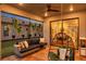 Relaxing patio features comfortable sectional sofa, hanging plants, and view to the home's interior through sliding glass doors at 4719 Tramanto Ln, Wesley Chapel, FL 33543