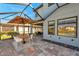 A tiled patio offers an inviting outdoor space with a dining area and comfortable lounge seating at 4719 Tramanto Ln, Wesley Chapel, FL 33543