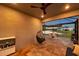 Beautiful screened lanai features an outdoor dining set and views of the lake and backyard at 4719 Tramanto Ln, Wesley Chapel, FL 33543