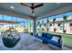 Relaxing outdoor patio with hanging plants, comfortable seating, and stylish decor for relaxing and entertaining at 4719 Tramanto Ln, Wesley Chapel, FL 33543