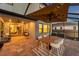 Covered lanai with dining area, hanging swing, and view into the home through large sliding glass doors at 4719 Tramanto Ln, Wesley Chapel, FL 33543