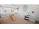 Open playroom features a whimsical mural, climbing structure and colorful books at 4719 Tramanto Ln, Wesley Chapel, FL 33543