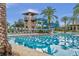 Community pool with a waterslide, tower, and seating on a sunny day at 4719 Tramanto Ln, Wesley Chapel, FL 33543