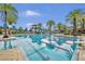 Community pool with palm trees, and lap lanes on a sunny day at 4719 Tramanto Ln, Wesley Chapel, FL 33543