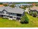 An aerial view shows the spacious backyard and screened patio, backing onto a serene pond within a beautiful community at 4744 Wandering Way, Wesley Chapel, FL 33544