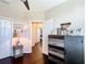 Neutral toned bedroom with hardwood floors, closet, chest of drawers, and ceiling fan at 4744 Wandering Way, Wesley Chapel, FL 33544