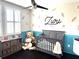 Bedroom featuring a gray crib, ceiling fan, and closet for ample storage at 4744 Wandering Way, Wesley Chapel, FL 33544