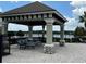 Community amenity featuring an inviting outdoor gazebo lounge with views of the water at 4744 Wandering Way, Wesley Chapel, FL 33544