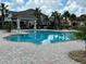 Community pool with inviting lounge area, perfect for relaxation and recreation under the sunny sky at 4744 Wandering Way, Wesley Chapel, FL 33544