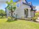Two-story home boasts a lush green lawn, tropical palms and gray siding, offering curb appeal and a touch of paradise at 4744 Wandering Way, Wesley Chapel, FL 33544