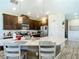 Spacious kitchen with stainless steel appliances, granite countertops, tile flooring, and modern lighting at 4744 Wandering Way, Wesley Chapel, FL 33544
