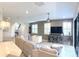 Cozy living room with tile floors, a ceiling fan, and a sliding glass door to the outdoors at 4744 Wandering Way, Wesley Chapel, FL 33544