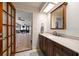 Lovely bathroom featuring a double-sink vanity with stone countertop and doorway to the sunroom at 4765 Lake Valencia W Blvd, Palm Harbor, FL 34684
