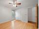 This bedroom has hardwood floors, a window, a ceiling fan and closet at 4765 Lake Valencia W Blvd, Palm Harbor, FL 34684