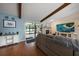 Bright living room showcasing vaulted ceilings, a fireplace, wood floors, and a seamless transition to the outdoors at 4765 Lake Valencia W Blvd, Palm Harbor, FL 34684