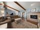Inviting living room with vaulted ceilings, a cozy fireplace, and sliding doors leading to the outdoors at 4765 Lake Valencia W Blvd, Palm Harbor, FL 34684