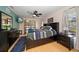 Comfortable main bedroom with a ceiling fan, neutral walls, wood floors, and windows overlooking the backyard at 4765 Lake Valencia W Blvd, Palm Harbor, FL 34684