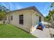 Exterior view of the house highlighting the side yard, with a well-maintained lawn and concrete pathway at 4932 Murray Hill Dr, Tampa, FL 33615
